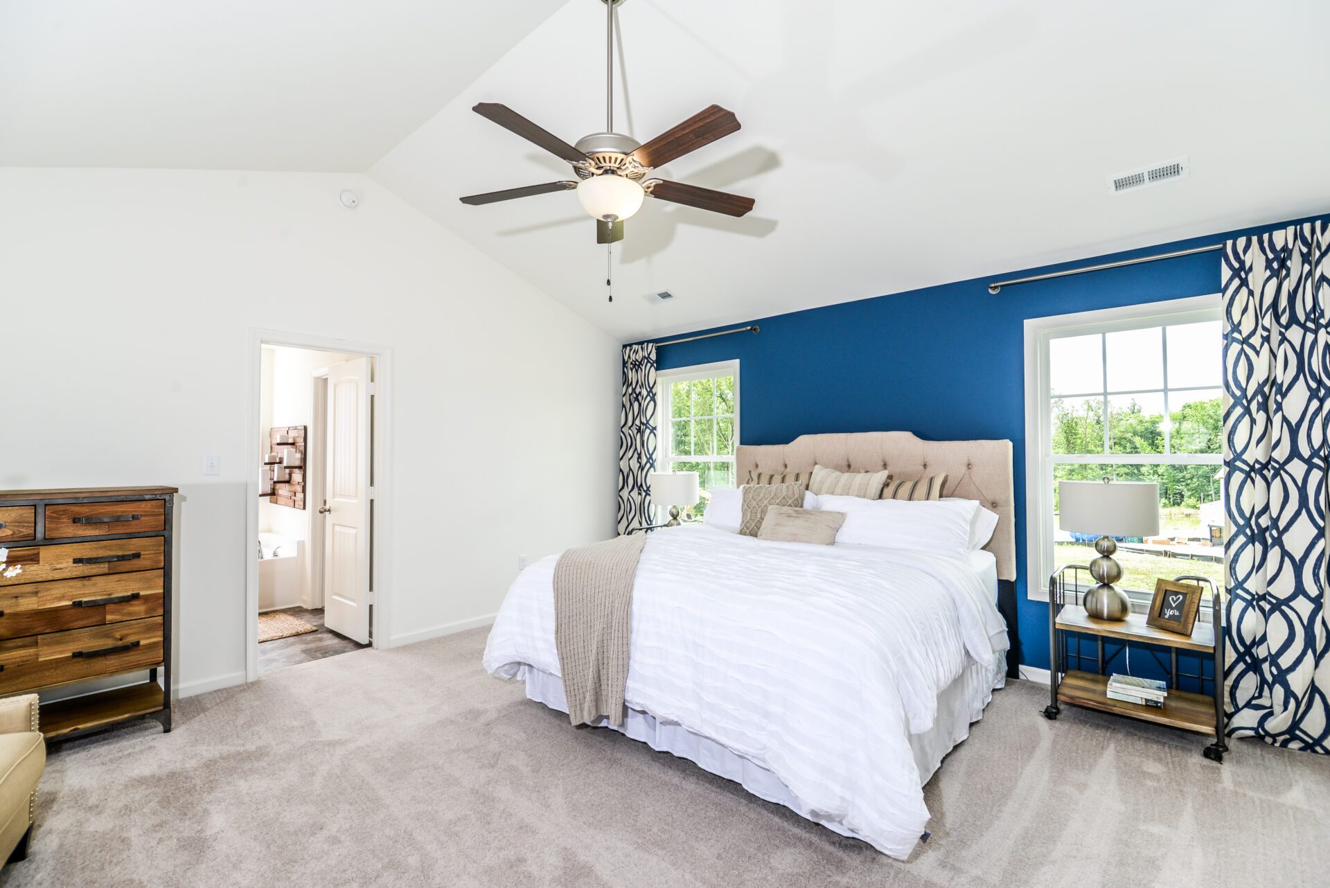 The Osprey primary suite with vaulted ceilings, private bath, walk-in closet